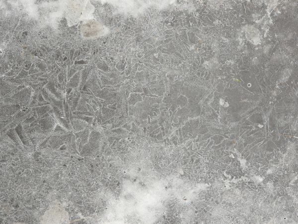 Cracked ice texture with small white air bubbles and cracks in the surface.